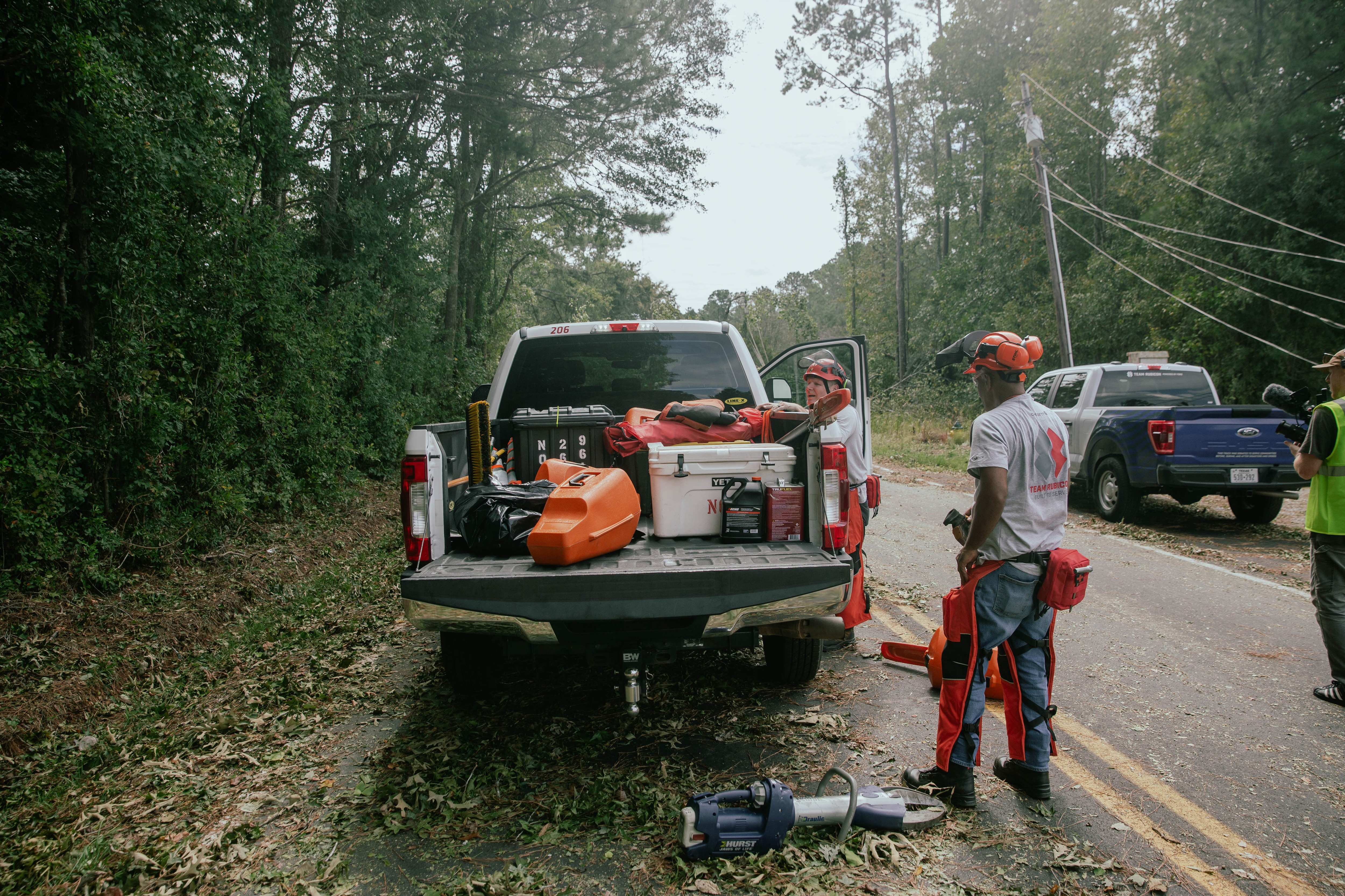 A group of volunteers helps repair a damaged roof.